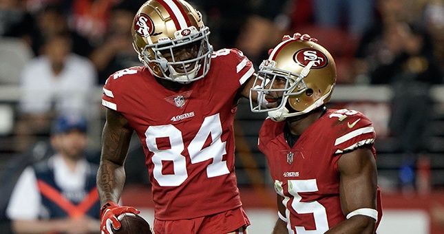 San Francisco 49ers wide receiver Kendrick Bourne (84) and wide receiver Pierre Garcon (15) celebrate against the Oakland Raiders during the third quarter at Levis Stadium.