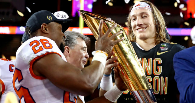 Clemson quarterback Trevor Lawrence celebrates with the national championship trophy after beating Alabama.