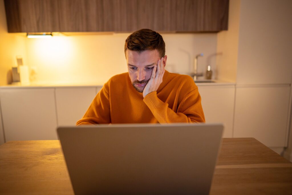 Bored man on a laptop